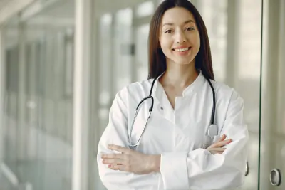 A confident woman in professional attire smiling at the camera